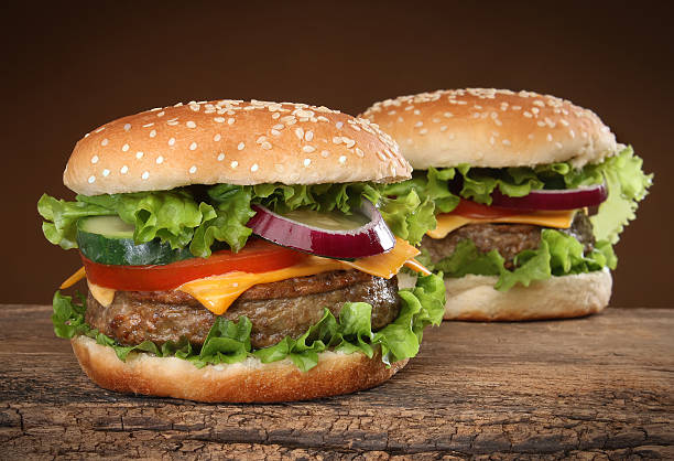 istock Two delicious hamburgers on wood background 500735585