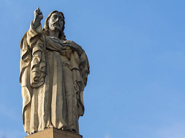 istock jesus christ statue with blue and clean sky background 500735603