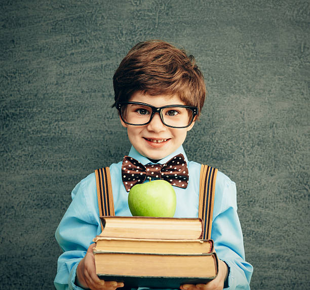 istock Young male student offering books and apple 500736279