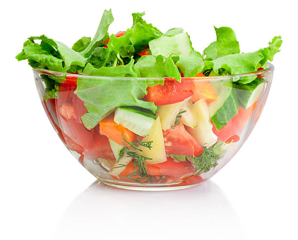 Fresh vegetable salad in transparent bowl isolated on white Fresh vegetable salad in transparent bowl isolated on white salad bowl photos stock pictures, royalty-free photos & images