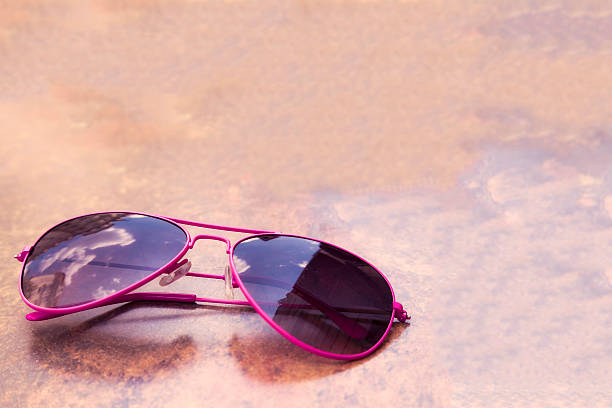 istock Pink Metallic Sunglasses on Brown Table 500740145
