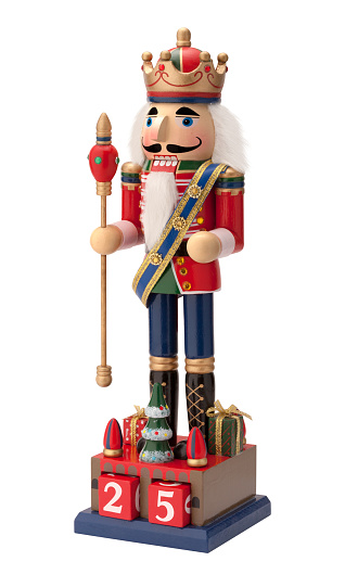 Wood Nutcracker at Christmas table with festive Christmas decorations and cookies