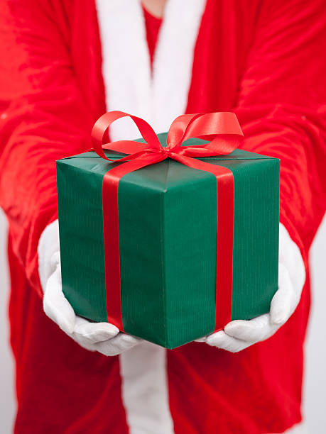 istock Santa Claus. He is holding a green box 500747302