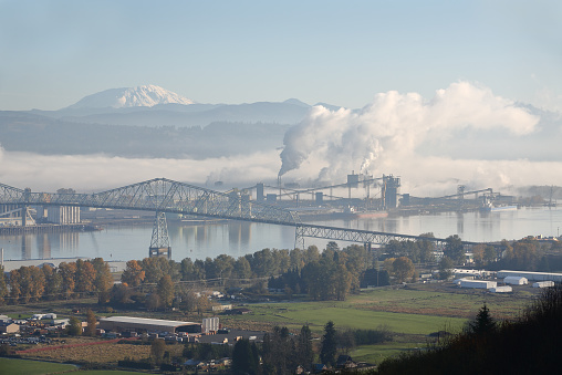 Longview, Washington State, USA. The Lewis and Clark Bridge crossing the Columbia River between Washington and Oregon. The top of Mount St. Helens in the background. 