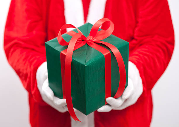 istock Santa Claus. He is holding a green box 500747398
