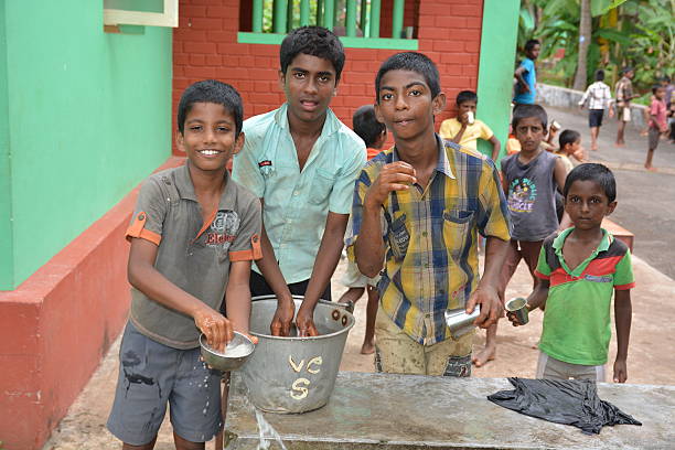 Learning kids Mumbai, India - October 27, 2015 - Children from childrens home drinking water and washing dishes from new well powered by charity from europe unicef stock pictures, royalty-free photos & images