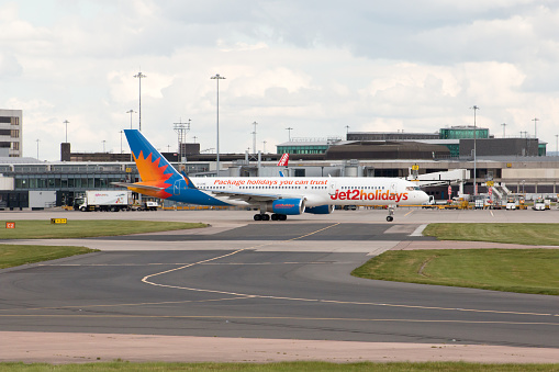 Manchester, United Kingdom - August 27, 2015: Jet2Holidays Boeing 757 narrow-body passenger plane (G-LSAE) taxiing on Manchester International Airport tarmac.