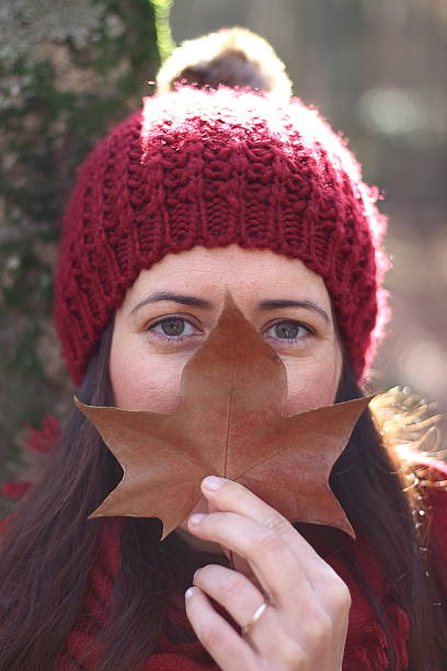 istock Young beautiful woman plays with beech leaves in the forest 500749954