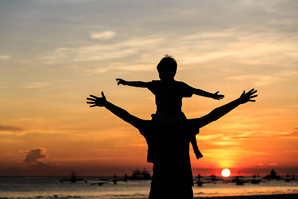 istock happy family on sunset beach 500750753