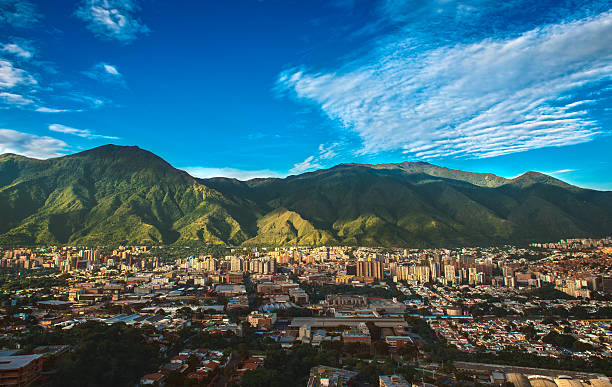 Caracas, Venezuela - Cityscape on a Sunny Afternoon Photograph of Caracas, a Venezuelan city under siege from organized crime and corruption, shot during a beautiful sunny November afternoon displaying the vibrant contrast between the inherent beauty of the city (as shown from a far wide angle shot) and the internal dangers of its daily life. venezuela stock pictures, royalty-free photos & images