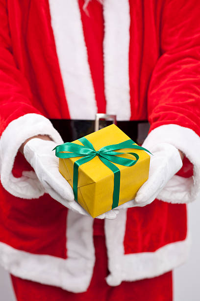istock Santa Claus. He is holding a yellow box 500750990
