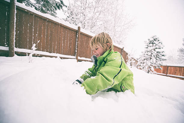 istock Boy playing in his backyard during a winter storm 500751152
