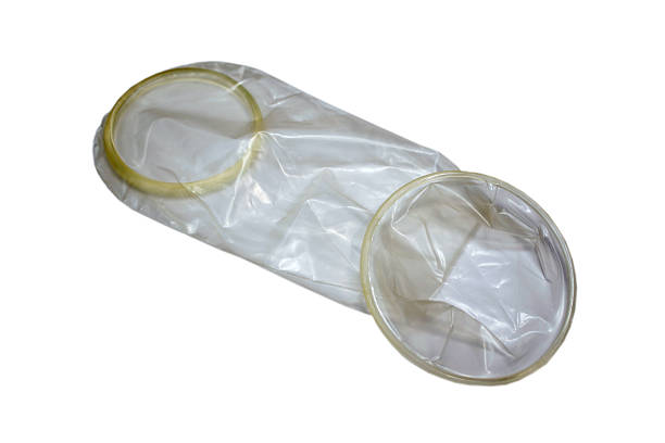 Female Condom Female Condom isolated on white. diaphragm contraceptive stock pictures, royalty-free photos & images