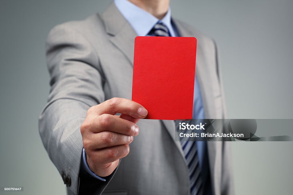 Businessman showing the red card Showing the red card concept for bad business practice, exclusion or criminal activity Punishment Stock Photo
