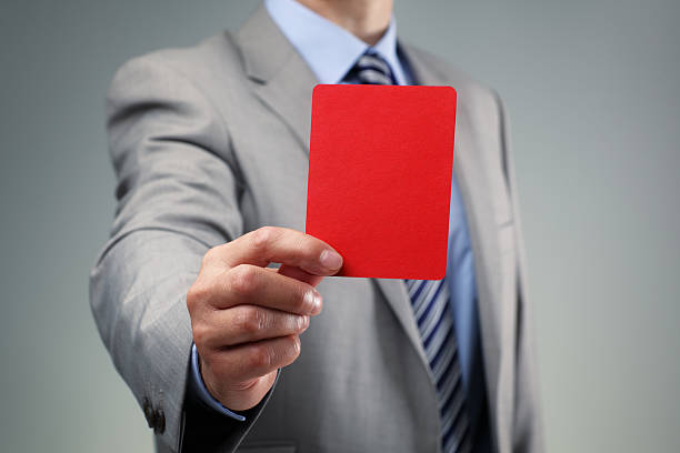 Businessman showing the red card Showing the red card concept for bad business practice, exclusion or criminal activity punishment photos stock pictures, royalty-free photos & images