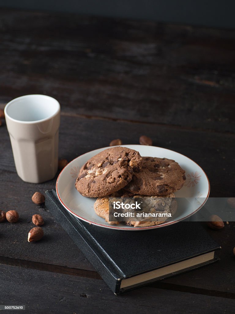 Chocolate chip cookies with an espresso and a notebook Delicious chocolate chip cookies with an espresso and a notebook on dark wooden background Bakery Stock Photo