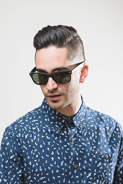 Blue Music Shirt Head shot of young man with sunglasses and a blue shirt with music notes on it. slicked back hair stock pictures, royalty-free photos & images