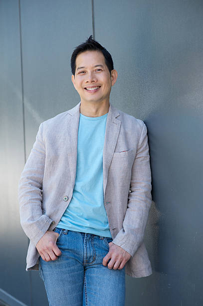 istock Smiling asian man standing outdoors 500752837