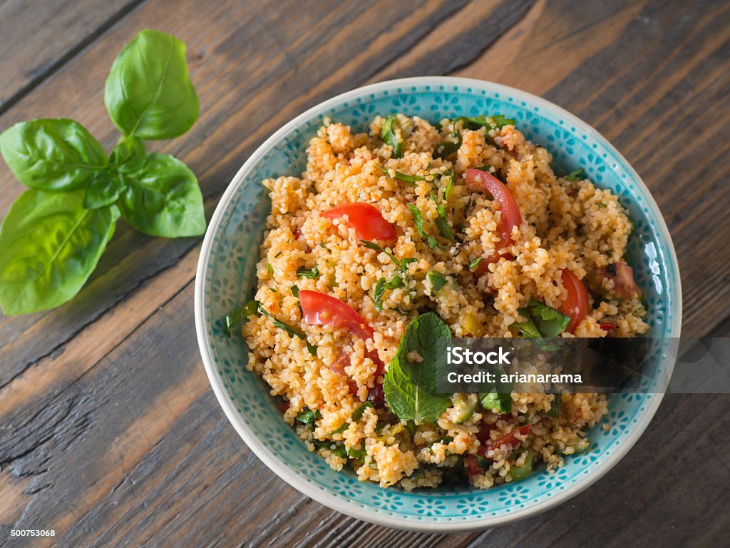 Couscous with tomatoes and basil Arabic traditional cuisine - Couscous with tomato and basil from the top Couscous Stock Photo