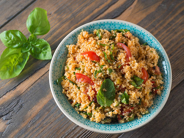 Couscous with tomatoes and basil Arabic traditional cuisine - Couscous with tomato and basil from the top couscous stock pictures, royalty-free photos & images