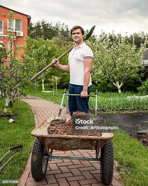 Smiling Man With Spade And Garden Wheelbarrow Stock Photo - Download Image Now - Activity, Adult, Adults Only