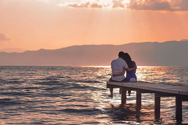 Photo of Couple Enjoying Sunset