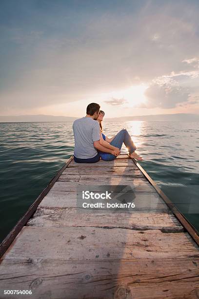 Romantic Young Couple Stock Photo - Download Image Now - Couple - Relationship, Pier, Sitting