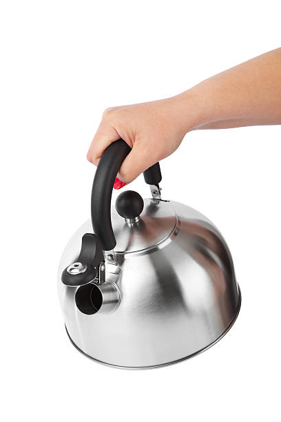 istock Stovetop whistling kettle in hand 500755262