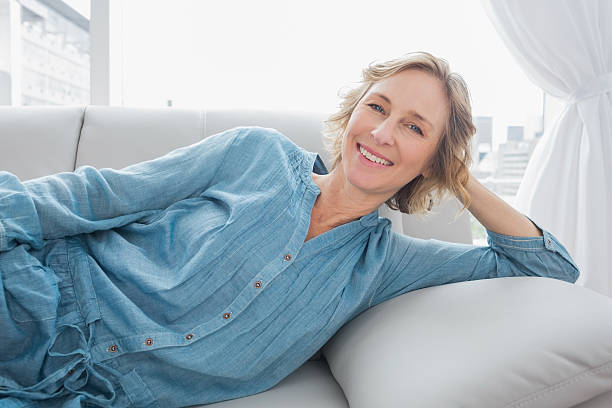 istock Cheerful woman relaxing on her couch 500755721