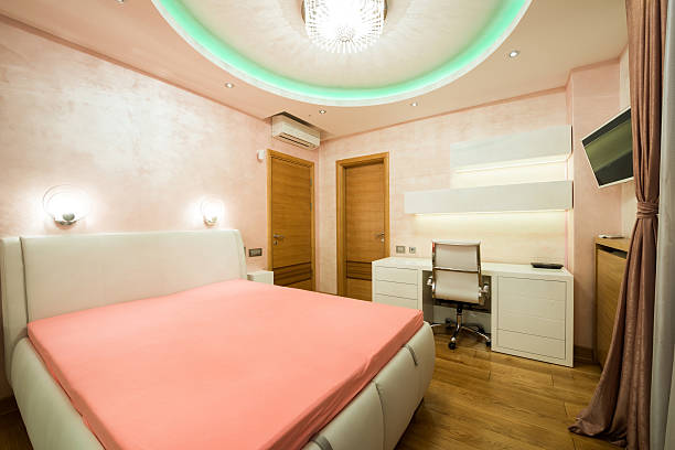 istock Interior of a modern orange bedroom with luxury colorful ceiling 500756280