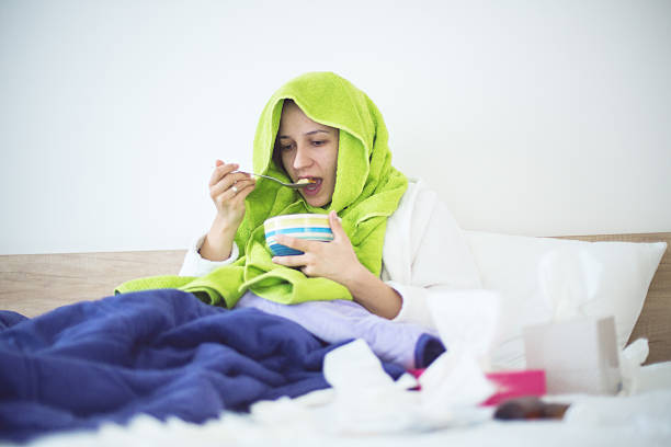 istock Eating chicken noodle soup in bed while sick 500756460