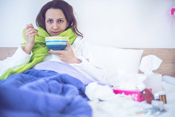istock Eating chicken noodle soup in bed while sick 500757196