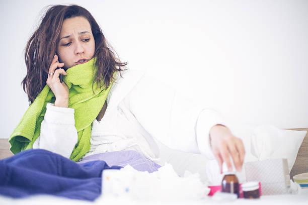 istock Sick Woman In Bed At Home Talking On Phone 500758340