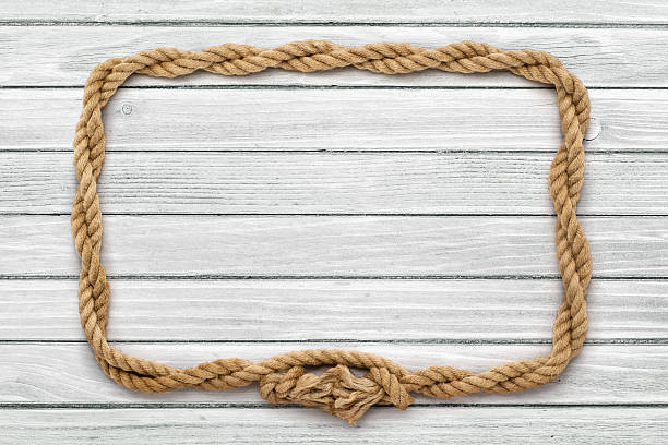 istock Rope frame on weathered white painted wooden board 500758696