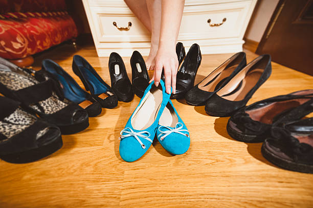 istock woman picking ballet flats rather than high heels 500767417