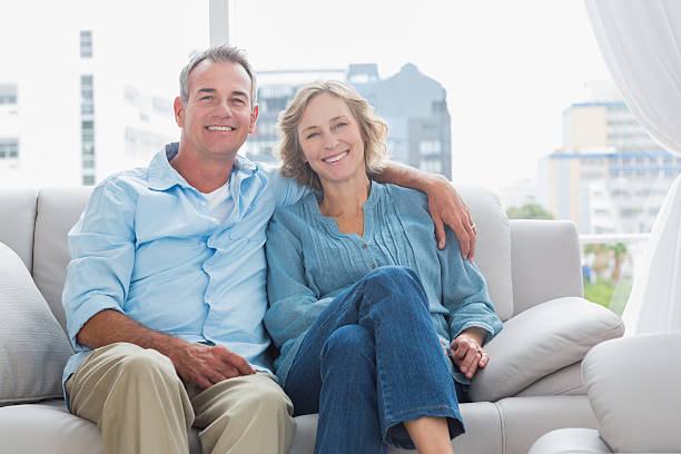 istock Happy couple relaxing on their couch 500767801