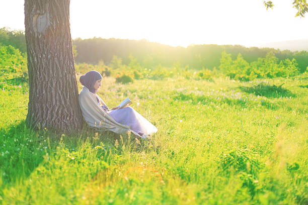 istock Woman reading book in the park 500768745