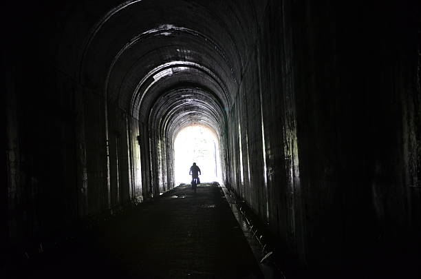 istock Bike Ride through a Long Dark Train Tunnel 500768919