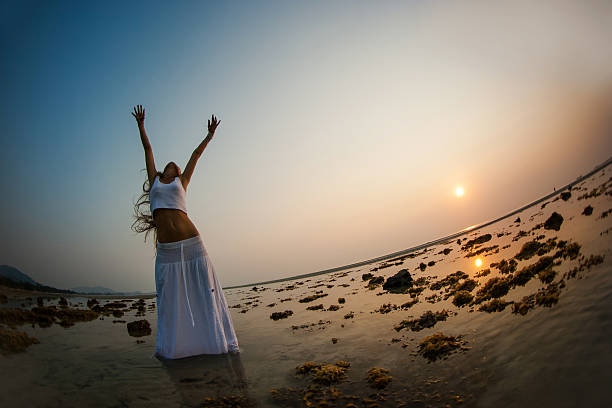 istock Beautiful woman is dancing on the beach at sunset 500769849