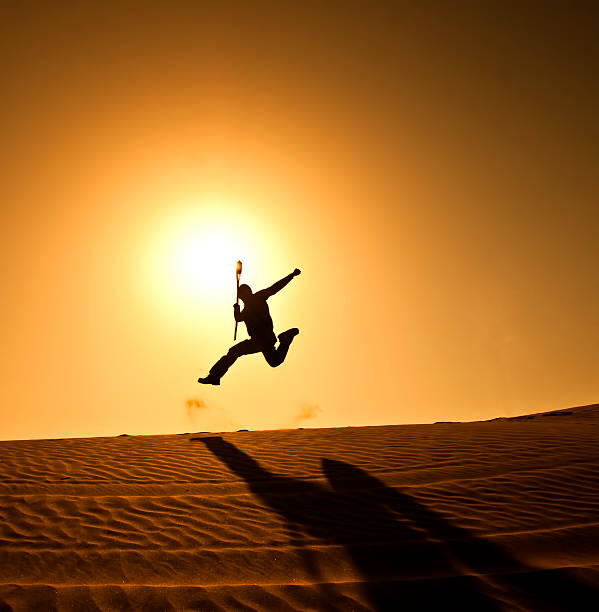 istock Silhouette of a man jumping in the desert 500770039