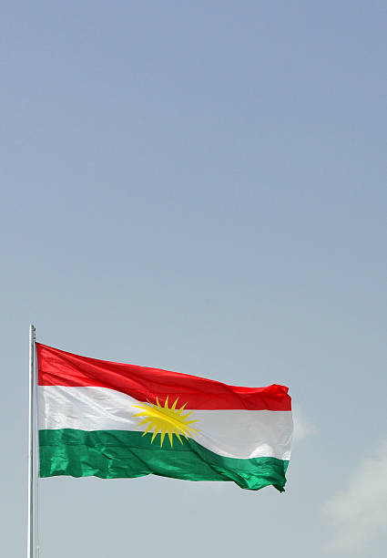 Flag of Kurdistan Erbil / Hewler, Kurdistan, Iraq: flag of Kurdistan against blue sky - Zoroastrian inspired sun disk and red, white and green stripes, no crescent... - photo by M.Torres kurdistan stock pictures, royalty-free photos & images