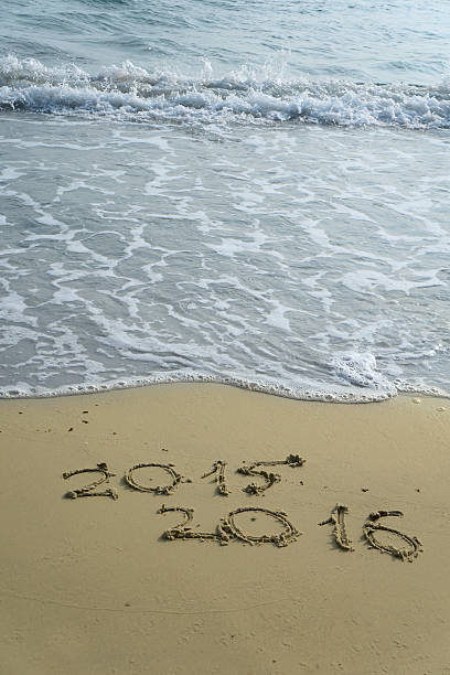 istock year 2015 and 2016 on the sand beach 500770896