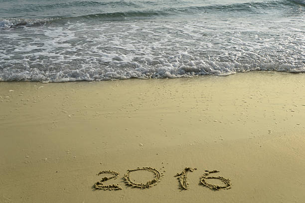 istock 2015 and 2016 year on the sand beach 500771100