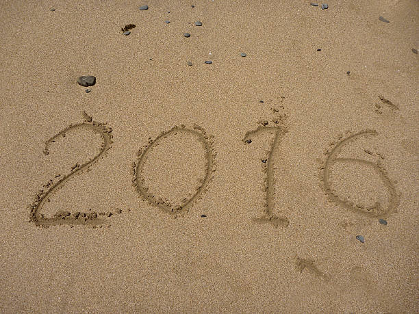 istock 2015 and 2016 year on the sand beach 500771116