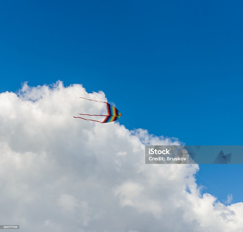 colorful kite colorful kite flying high in the sky with a cloud Above Stock Photo