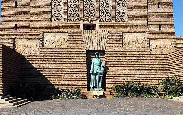 Pretoria, South Africa - August 8, 2015: A statue of a Voortrekker woman and children at the entrance of the Voortrekker Monument, symbolizing the bravery of the women of the Great Trek.