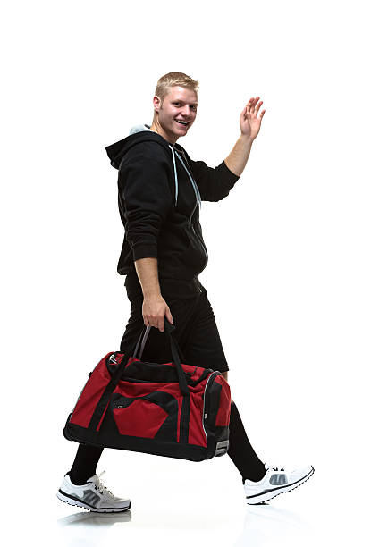 College student walking with gym bag