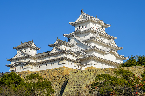 Himeji, Japan - November 27, 2015: Famous Himeji Castle in Japan used by Shoguns and Samurais. Photo was taken during a cold autumn afternoon from the park in front of the castle, and contains no people.
