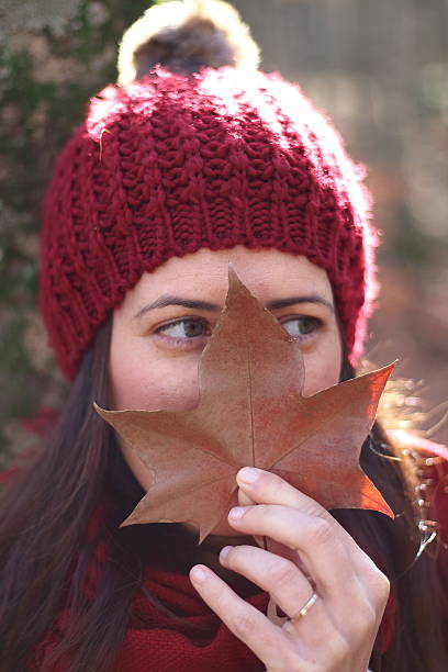 istock Young beautiful girl plays with beech leaves in a forest 500778152