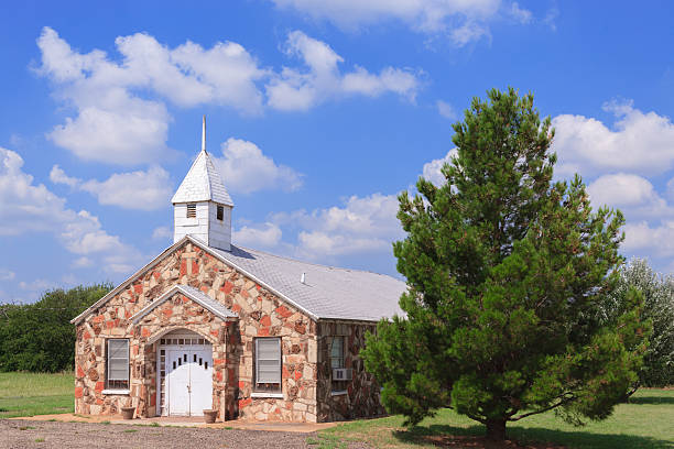 istock country church, rock building, West Texas, puffy clouds, blue sky 500779220